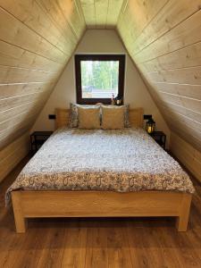 a bedroom with a large bed in a attic at Koperkowe Domki Zakopane in Zakopane +51 photos