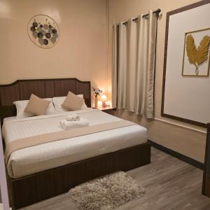 a bedroom with a bed with a towel on it at Victory place 2 (Golden Mount) in Bangkok