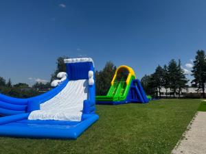 a group of playground equipment on a grass field at Hotel Dobczyce in Dobczyce