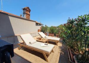 two chaise lounges and chairs on a patio at La Cà de' mi Vecc in Fino Mornasco