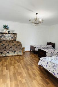 a room with two beds and a chandelier at Family hotel ucha in Iprari