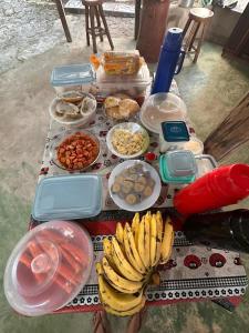 a table full of food with bananas and other foods at POUSADA Botos de Alter quarto compartilhado in Alter do Chao