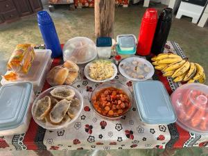 a table with many plates of food on it at POUSADA Botos de Alter quarto compartilhado in Alter do Chao