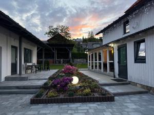 a courtyard with a flower garden next to a building at Bukovets' in Yaremche
