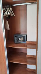 a microwave sitting on a shelf in a closet at Departamento Dina Huapi Bariloche in Dina Huapi