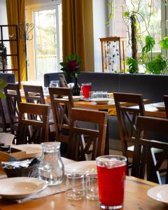 a restaurant with tables and chairs with drinks on them at Hotel Dobczyce in Dobczyce