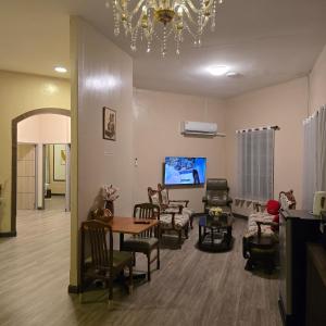 a living room with chairs and a table and a tv at Victory place 2 (Golden Mount) in Bangkok