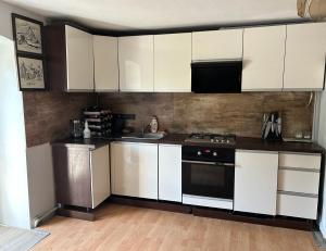 a kitchen with white cabinets and a stove top oven at Dolna 64 in Strzegom