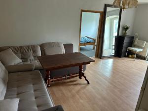 a living room with a couch and a table at Dolna 64 in Strzegom
