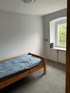 a bedroom with a bed and a window at Dolna 64 in Strzegom