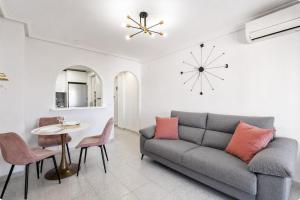 a living room with a couch and a table at Mar y Sol in Torrevieja +20 photos