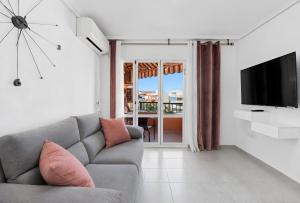 a living room with a couch and a flat screen tv at Mar y Sol in Torrevieja