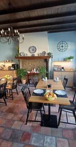 a dining room with tables and chairs and a fireplace at 't Kabinet in Blankenberge