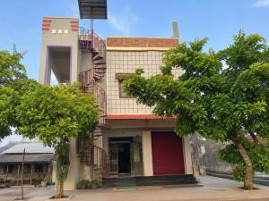 a building with a fire escape on the side of it at Sri varahi rest house in Avanigadda