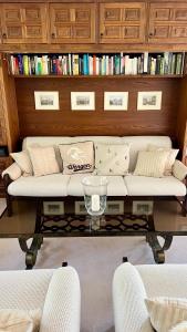 a living room with a white couch and a glass table at Chalet Steinbock Wengen in Wengen +21 photos