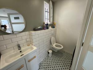 a bathroom with a sink and a toilet and a mirror at Emmanuel INN 4 in Drancy +36 photos