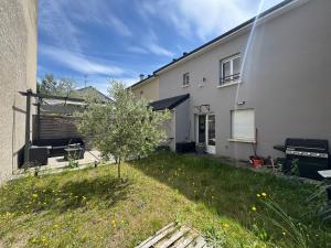 a white house with a small tree in the yard at Emmanuel INN 4 in Drancy