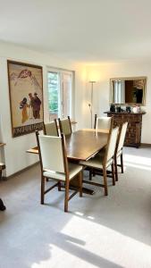 a dining room with a wooden table and chairs at Chalet Steinbock Wengen in Wengen
