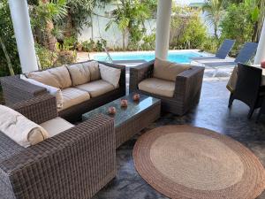 a patio with couches and a table and a pool at Daniblue in Riambel