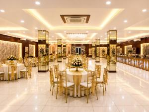 a banquet hall with tables and chairs and a buffet at The Dwelling Inn in Greater Noida