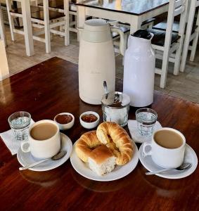 a table with coffee and croissants and two cups of coffee at Rio Termal in Federación