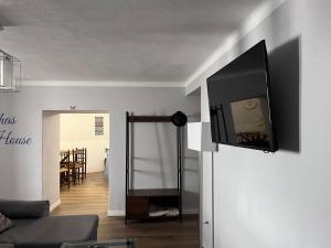 a living room with a flat screen tv on the wall at Perquilhas House in Freixial do Campo