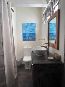 a bathroom with a white toilet and a sink at Daniblue in Riambel +6 photos