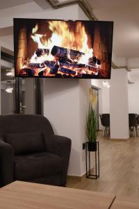 a living room with a fire screen on the wall at Ares Chalet in Horezu
