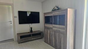 a large wooden entertainment center with a flat screen tv at Manötscherhof in Tires