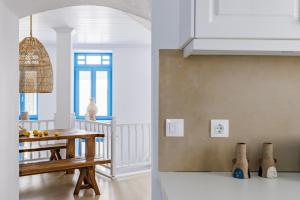 a kitchen with a table and a dining room at Maison Mariel in Skopelos Town
