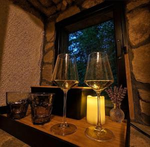 two glasses of wine on a table with a window at Old mill in Štore