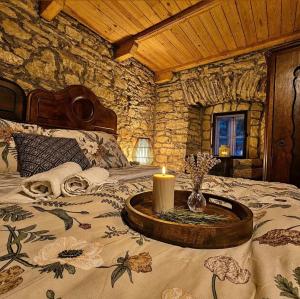 a bedroom with a bed with a candle on it at Old mill in Štore