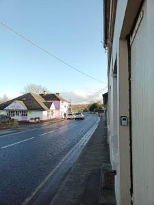 a street with a car parked on the side of a building at Bayview in Ballysadare