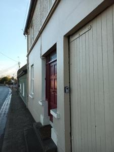 a building with a red door on the side of it at Bayview in Ballysadare