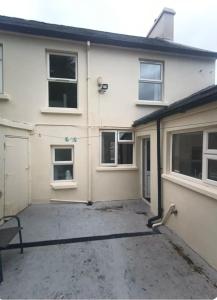 a white house with a parking lot in front of it at Bayview in Ballysadare