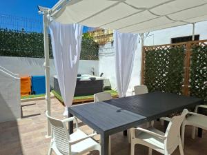a table and chairs under an umbrella on a patio at Su ciaccu in Nulvi