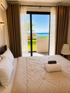 a bedroom with a bed with a view of the ocean at La Terrace Brocus in Bouchon +31 photos