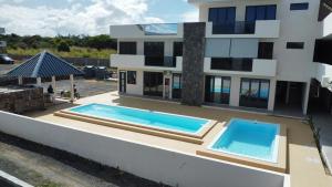 two swimming pools on the roof of a building at La Terrace Brocus in Bouchon