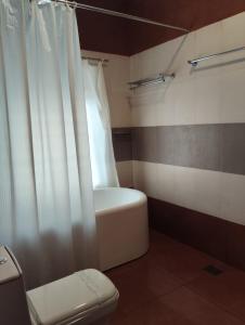 a bathroom with a toilet and a shower curtain at Hillview Beach Resort in Varkala +272 photos