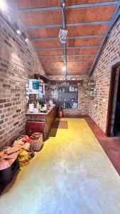 an empty room with a brick wall at AV Meadows in Kanchipuram