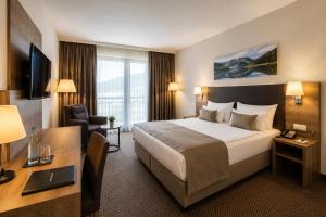a hotel room with a bed and a desk at Hotel M K in Nuremberg