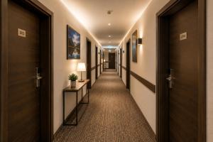 a corridor of a hotel hallway with doors at Hotel M K in Nuremberg