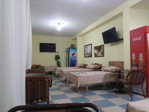 a room with a row of beds in a room at Roland Palaj House in Shkodër +37 photos