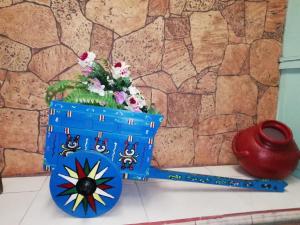 a blue pot with flowers in it next to a vase at Hospedaje del norte in Quesada