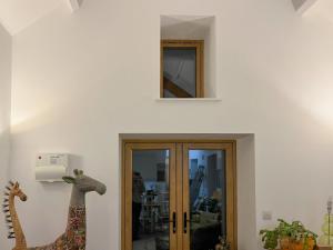 a room with a window and a giraffe on the wall at Maggie's Place in Holsworthy