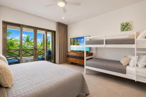 a bedroom with two bunk beds and a balcony at Casa Seven Ocean Front with Private C hef Included in Isla Mujeres +54 photos