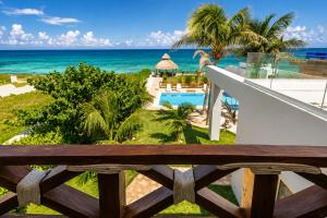 a view of the ocean from the balcony of a resort at Casa Seven Ocean Front with Private C hef Included in Isla Mujeres
