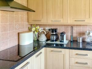 a kitchen counter with a coffee maker and a blender at California Halt in Scratby