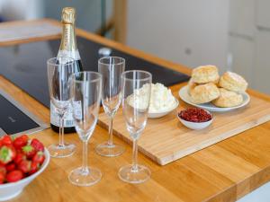 a table with wine glasses and a bottle of champagne at Wrens Perch in Brixham