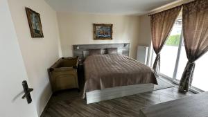 a bedroom with a bed and a large window at SONNENSEITE 2 in Laboe